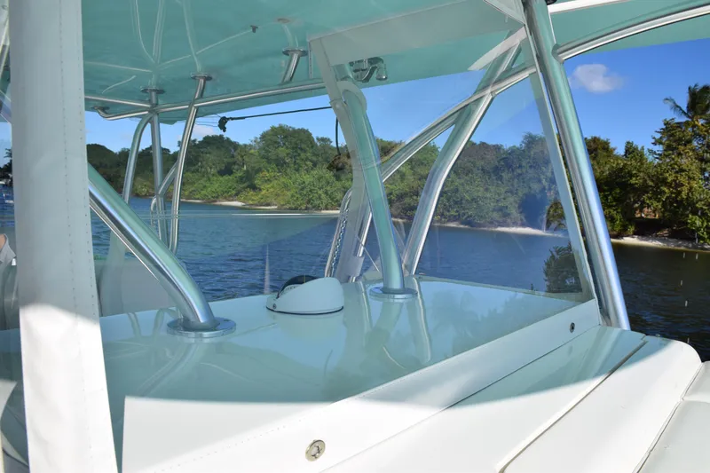 Slide: The Image of 2022 SeaVee 390Z boat interior with scenic water and lush greenery background. - 26