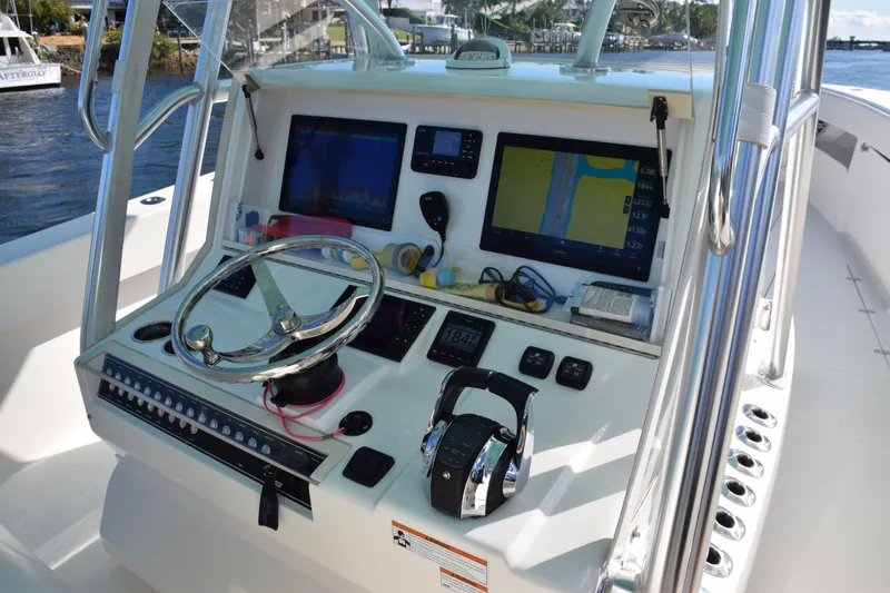 Slide: The Image of 2022 SeaVee 390Z boat dashboard with navigation screens and controls. - 24
