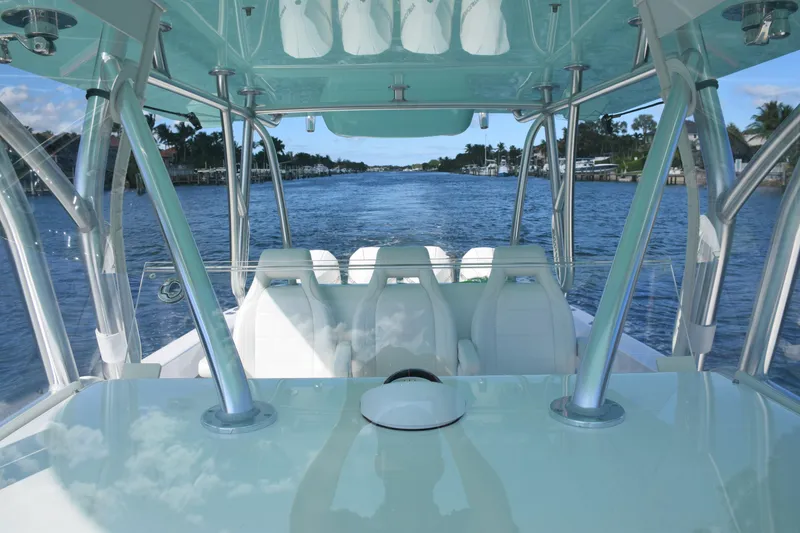 Slide: The Image of 2022 SeaVee 390Z boat interior with white seating, cruising on a scenic waterway. - 18
