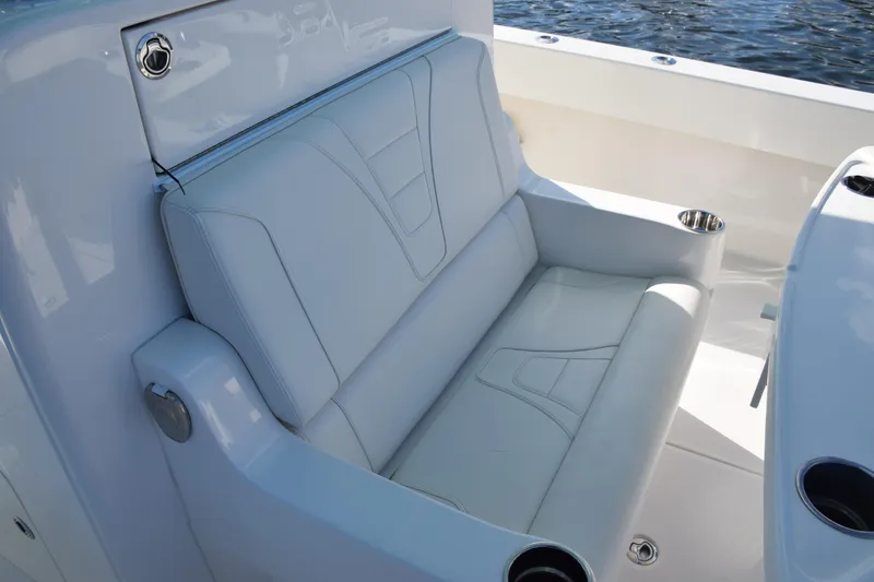 Slide: The Image of Luxurious seating on 2022 SeaVee 390Z boat, featuring sleek white upholstery and cup holders. - 15