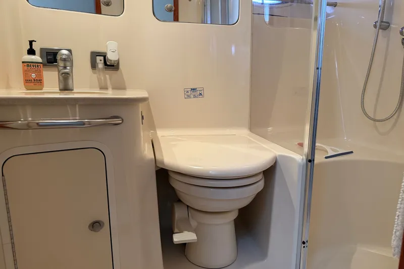 Slide: The Image of Bathroom interior of 2004 Sea Ray 480 Sedan Bridge yacht, featuring toilet and shower. - 43