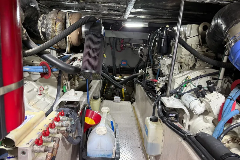Slide: The Image of Engine room of a 2004 Sea Ray 480 Sedan Bridge, showcasing mechanical components and equipment. - 44