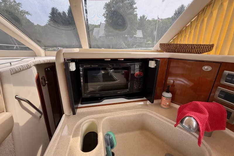 Slide: The Image of Interior of 2004 Sea Ray 480 Sedan Bridge with microwave and sink area. - 28