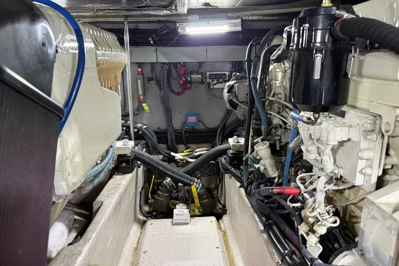 Slide: The Image of Engine room of a 2004 Sea Ray 480 Sedan Bridge, showcasing mechanical components and wiring. - 47
