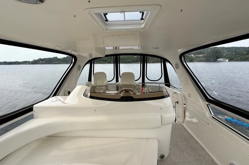 Slide: The Image of Interior view of 2004 Sea Ray 480 Sedan Bridge yacht with panoramic windows. - 18