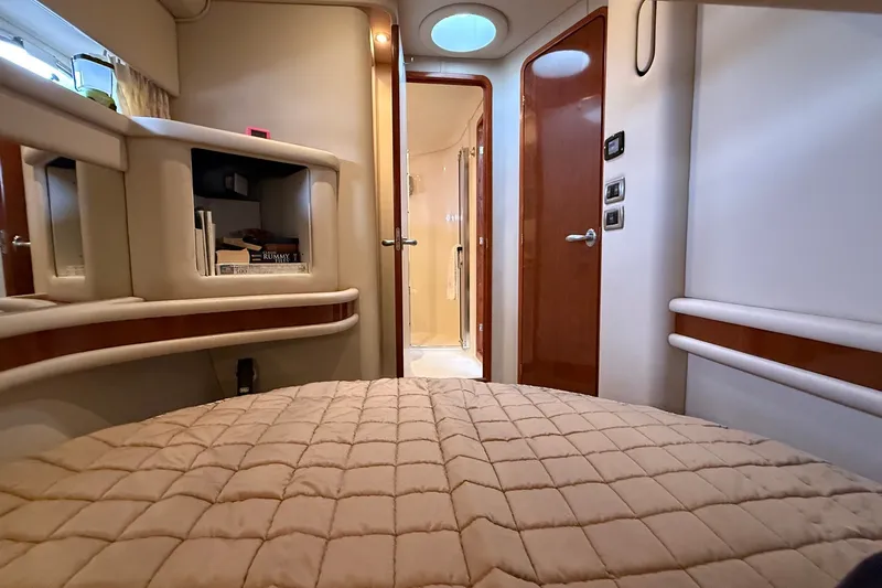 Slide: The Image of Luxurious interior of 2004 Sea Ray 480 Sedan Bridge yacht cabin with cozy bedding. - 36