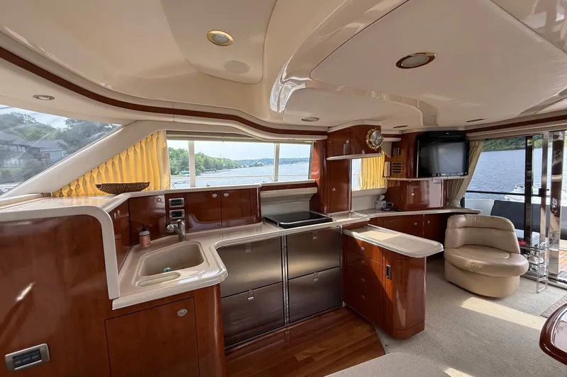 Slide: The Image of Luxurious interior of a 2004 Sea Ray 480 Sedan Bridge yacht with modern kitchen amenities. - 26