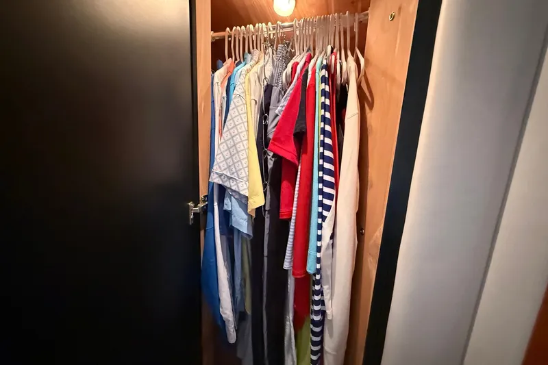 Slide: The Image of Clothes hanging in a closet aboard a 2004 Sea Ray 480 Sedan Bridge yacht. - 37