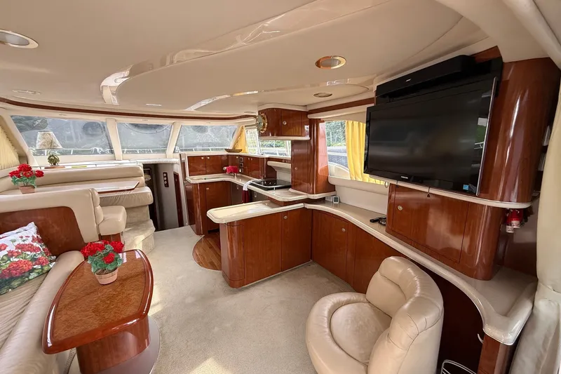 Slide: The Image of Luxurious interior of a 2004 Sea Ray 480 Sedan Bridge yacht with elegant wood finishes. - 22