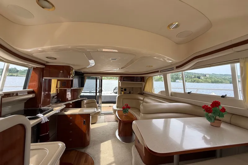 Slide: The Image of Luxurious interior of a 2004 Sea Ray 480 Sedan Bridge yacht with elegant furnishings and scenic views. - 29