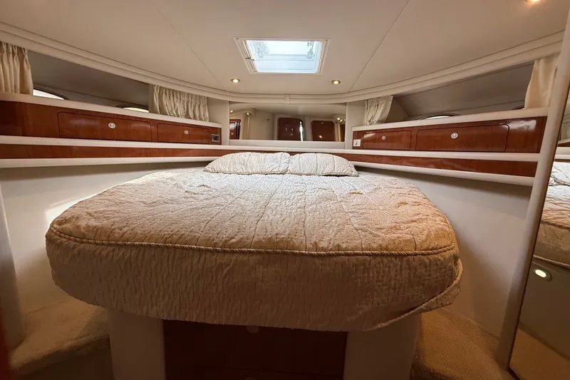 Slide: The Image of Luxurious 2004 Sea Ray 480 Sedan Bridge cabin with cozy bed and elegant wood cabinetry. - 34