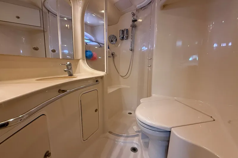 Slide: The Image of Luxurious bathroom in 2004 Sea Ray 480 Sedan Bridge yacht, featuring shower and toilet. - 40