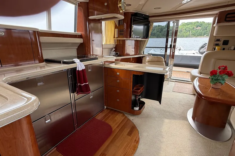 Slide: The Image of Luxurious interior of a 2004 Sea Ray 480 Sedan Bridge yacht with elegant wood finishes. - 31