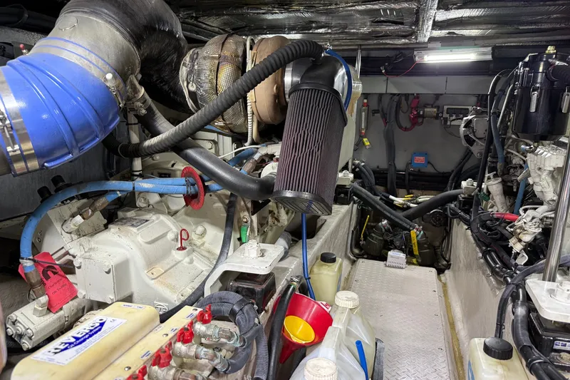 Slide: The Image of Engine room of a 2004 Sea Ray 480 Sedan Bridge, showcasing mechanical components and wiring. - 46