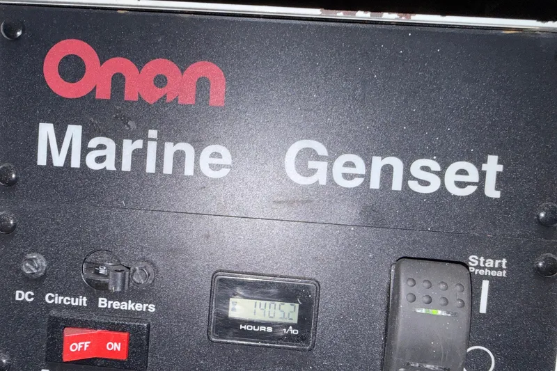 Slide: The Image of Onan Marine Genset control panel on 2004 Sea Ray 480 Sedan Bridge. - 54
