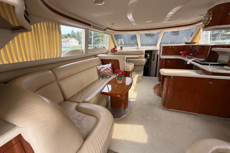 Slide: The Image of Luxurious interior of a 2004 Sea Ray 480 Sedan Bridge yacht with elegant seating and decor. - 20