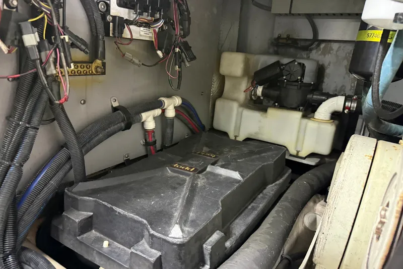 Slide: The Image of Engine compartment of a 2004 Sea Ray 480 Sedan Bridge with wiring and components. - 53