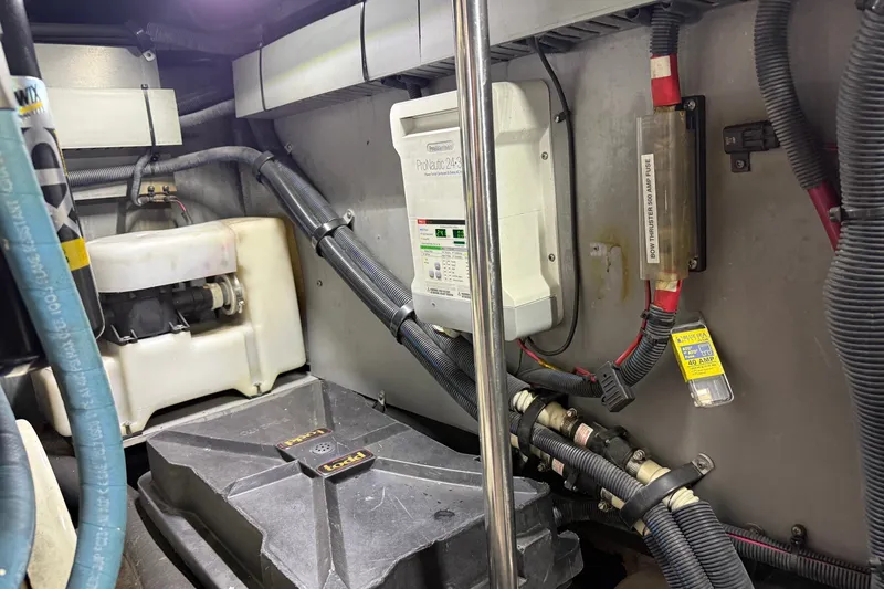 Slide: The Image of Engine room of 2004 Sea Ray 480 Sedan Bridge with electrical components and wiring. - 48