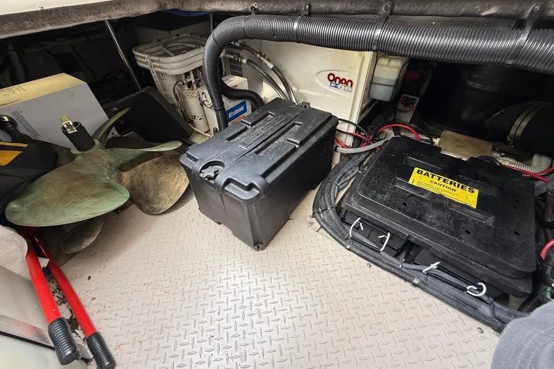 Slide: The Image of Engine room of 2004 Sea Ray 480 Sedan Bridge with batteries and propeller. - 52