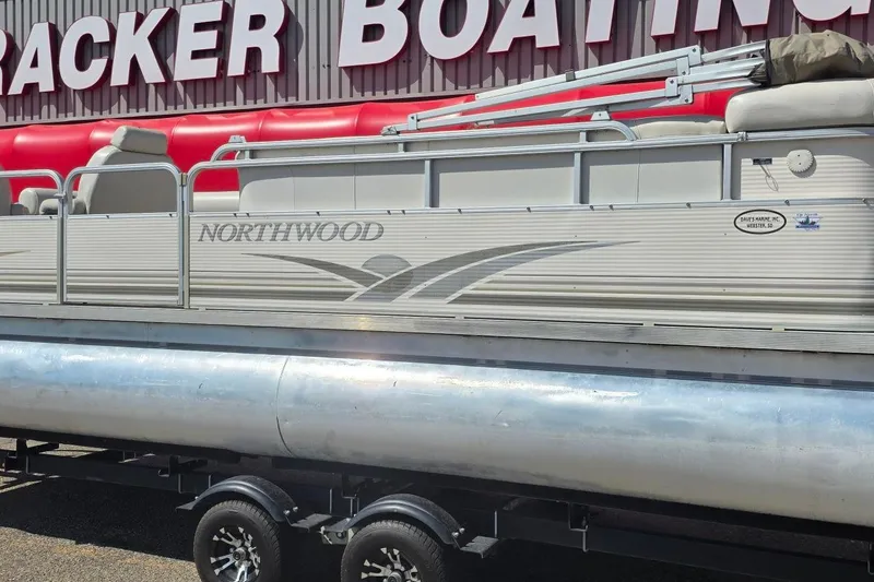 The Image of 2003 Northwood 2223 Traditions pontoon boat on trailer at Tracker Boating dealership. - 0