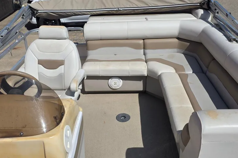 Slide: The Image of 2003 Northwood 2223 Traditions boat interior with beige seating and steering console. - 7