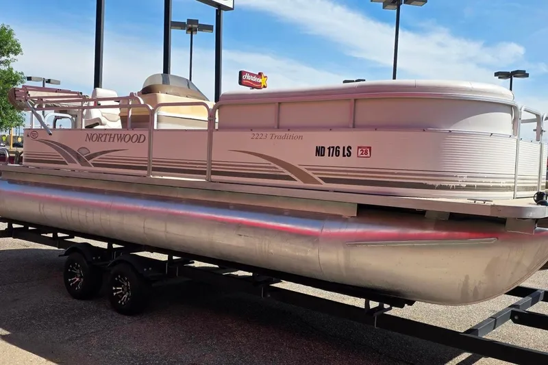 Slide: The Image of 2003 Northwood 2223 Traditions pontoon boat on trailer, parked outdoors. - 5
