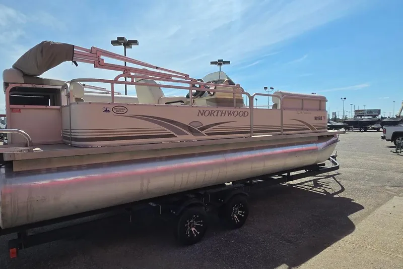 Slide: The Image of 2003 Northwood 2223 Traditions pontoon boat on trailer under clear blue sky. - 2