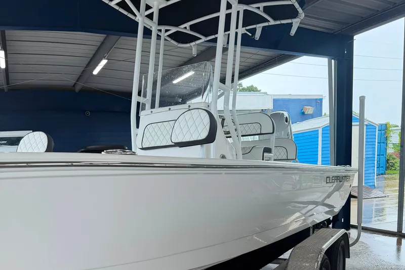 Slide: The Image of 2025 Clearwater 21 Bay boat in showroom, featuring sleek design and modern seating. - 3
