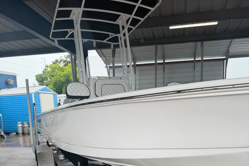 Slide: The Image of 2025 Clearwater 21 Bay boat under shelter, showcasing sleek design and modern features. - 2