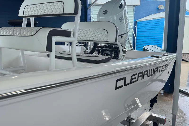 Slide: The Image of 2025 Clearwater 21 Bay boat with sleek design and modern seating in a showroom. - 8