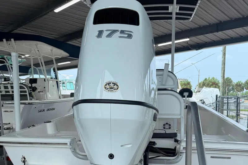 Slide: The Image of 2025 Clearwater 21 Bay boat with 175 horsepower engine in a covered marina. - 11