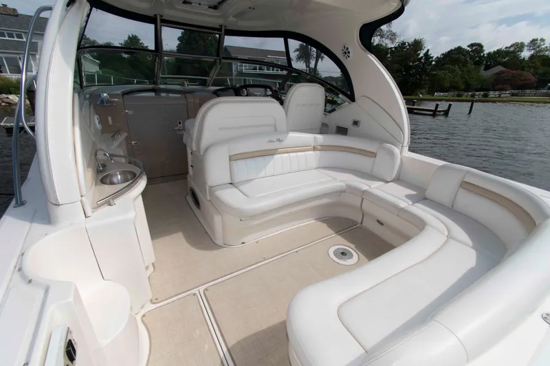 Slide: The Image of 2009 Sea Ray Sundancer 400 yacht interior with white seating and water view. - 2