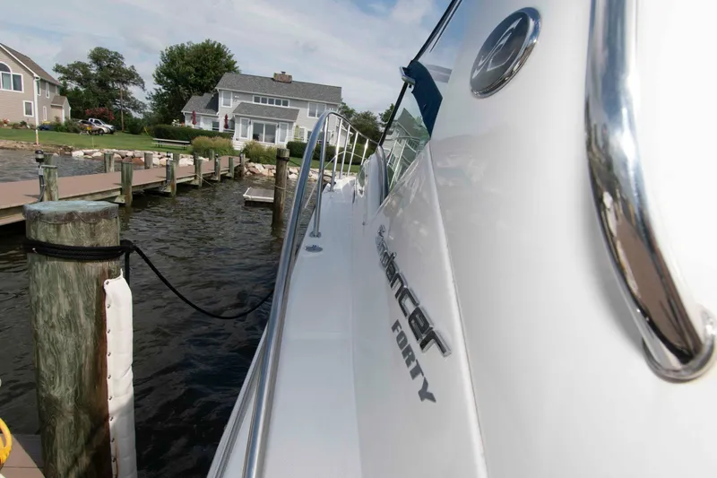 Slide: The Image of 2009 Sea Ray Sundancer 400 yacht docked near waterfront homes. - 8