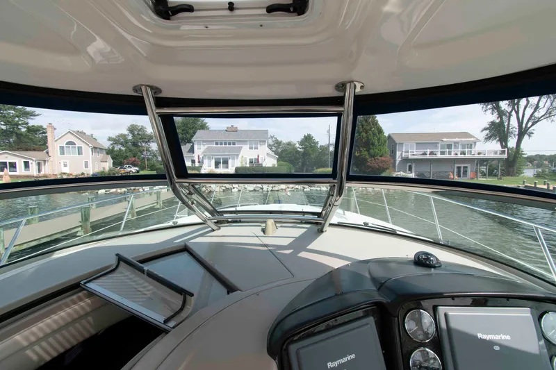 Slide: The Image of Interior view from the helm of a 2009 Sea Ray Sundancer 400 yacht, overlooking waterfront homes. - 9