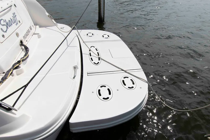 Slide: The Image of 2009 Sea Ray Sundancer 400 swim platform on water, featuring sleek design and mooring lines. - 7