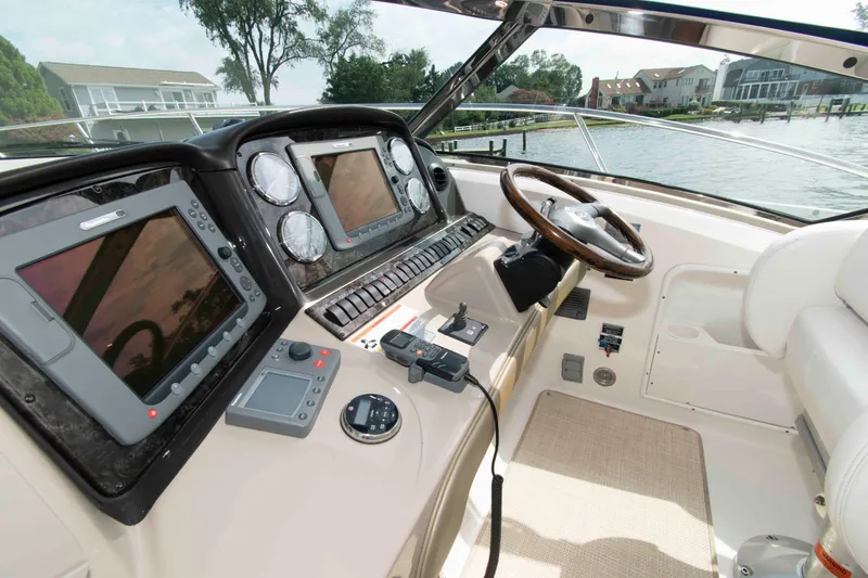 Slide: The Image of Interior helm of 2009 Sea Ray Sundancer 400 yacht with navigation equipment and steering wheel. - 4