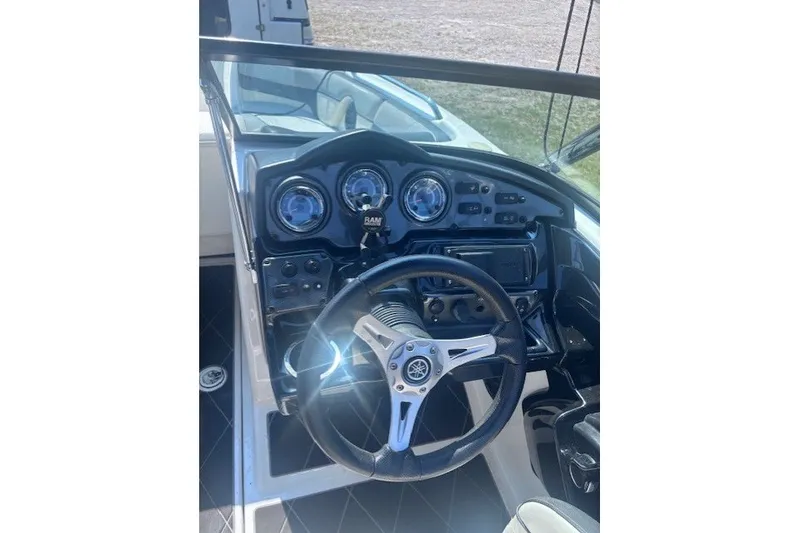 Slide: The Image of 2013 Yamaha Boats 212X dashboard with steering wheel and instrument panel. - 6
