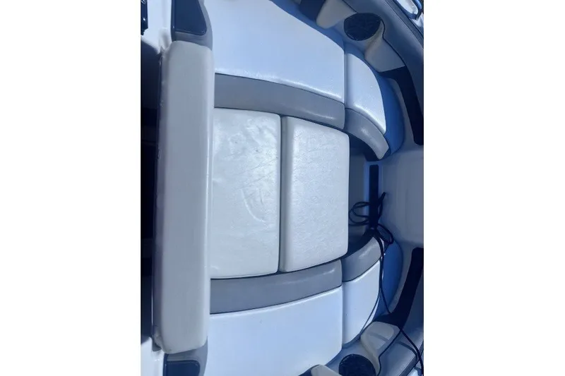 Slide: The Image of Interior seating of a 2013 Yamaha Boats 212X, featuring white and gray upholstery. - 8