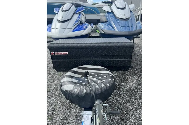 Slide: The Image of 2024 Yamaha PWC FX Cruiser SVHO jet skis on trailer with storage box and tire cover. - 13