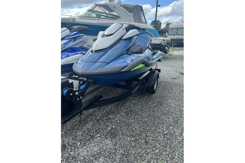Slide: The Image of 2024 Yamaha PWC FX Cruiser SVHO in blue, parked on a trailer, gravel background. - 2