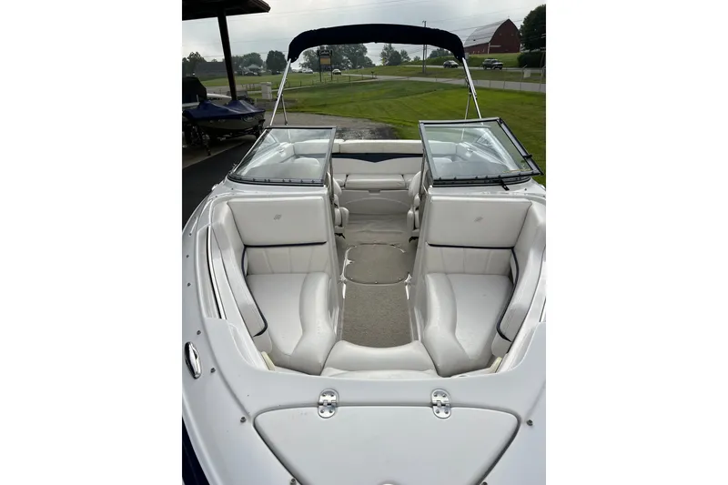 Slide: The Image of 2010 Four Winns H210 boat interior with white seating and open windshield. - 7