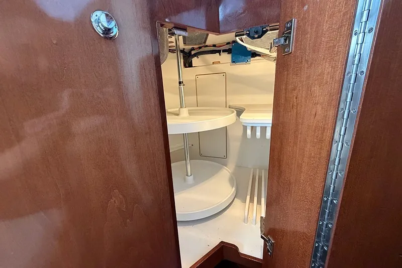 Slide: The Image of Open wooden cabinet with circular shelves inside a 2009 Meridian 391 Sedan. - 17