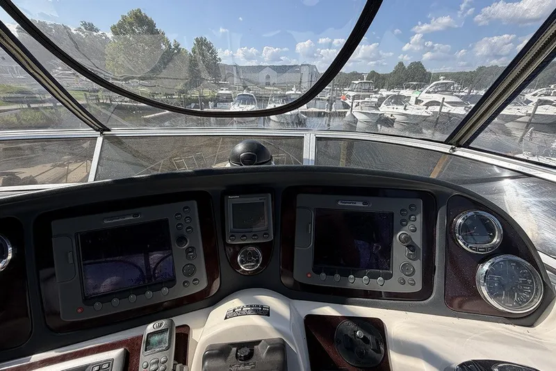 Slide: The Image of Cockpit view of 2009 Meridian 391 Sedan yacht with navigation equipment and marina backdrop. - 33