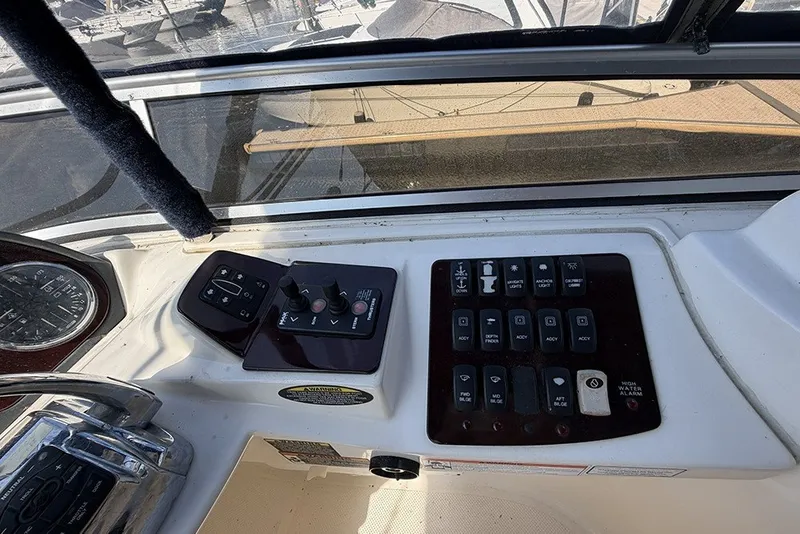 Slide: The Image of Control panel of a 2009 Meridian 391 Sedan yacht with various switches and dials. - 34