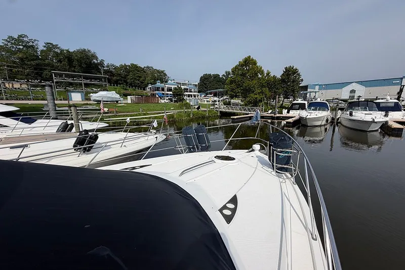 Slide: The Image of 2009 Meridian 391 Sedan docked at a marina with other boats and lush greenery. - 43