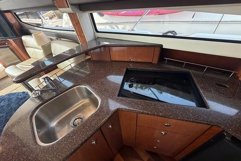 Slide: The Image of Luxurious kitchen area in a 2009 Meridian 391 Sedan yacht with sleek countertops and modern fixtures. - 15