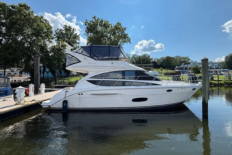 The Image of 2009 Meridian 391 Sedan yacht docked at marina under clear blue sky. - 2