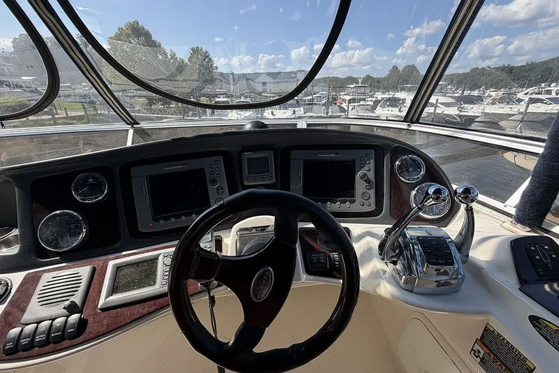 Slide: The Image of Cockpit view of 2009 Meridian 391 Sedan yacht with steering wheel and control panels. - 31