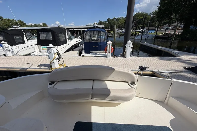 Slide: The Image of 2009 Meridian 391 Sedan at dock with seating area, surrounded by other boats. - 6