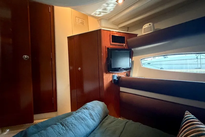 Slide: The Image of Interior of 2009 Meridian 391 Sedan yacht with wood cabinetry and a small TV. - 27